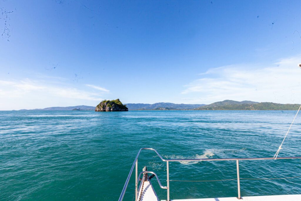 A scenic view of bright blue water and Koh Samui in the distance
